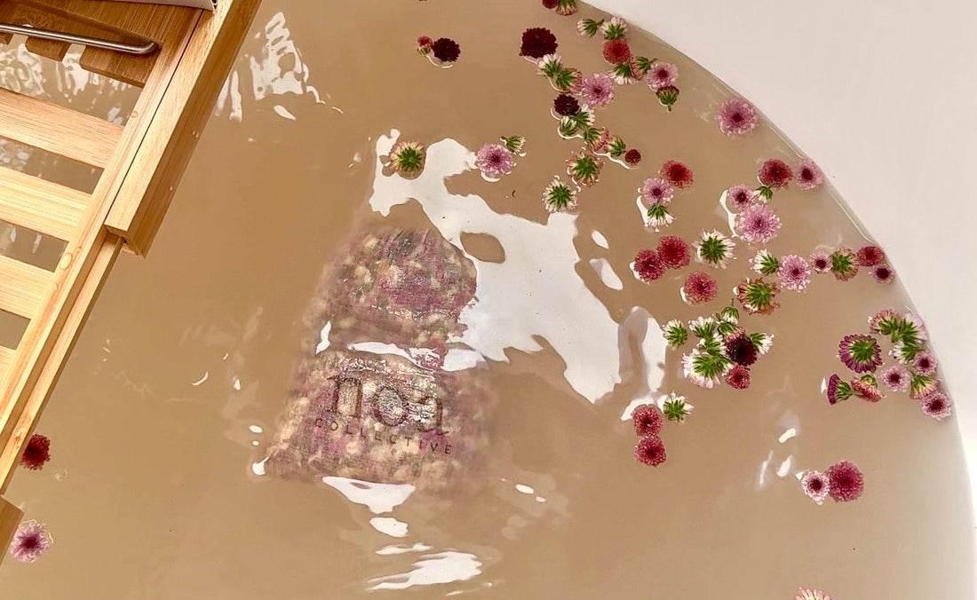 bath tea steeping in warm water with dried botanicals in a cotton bag
